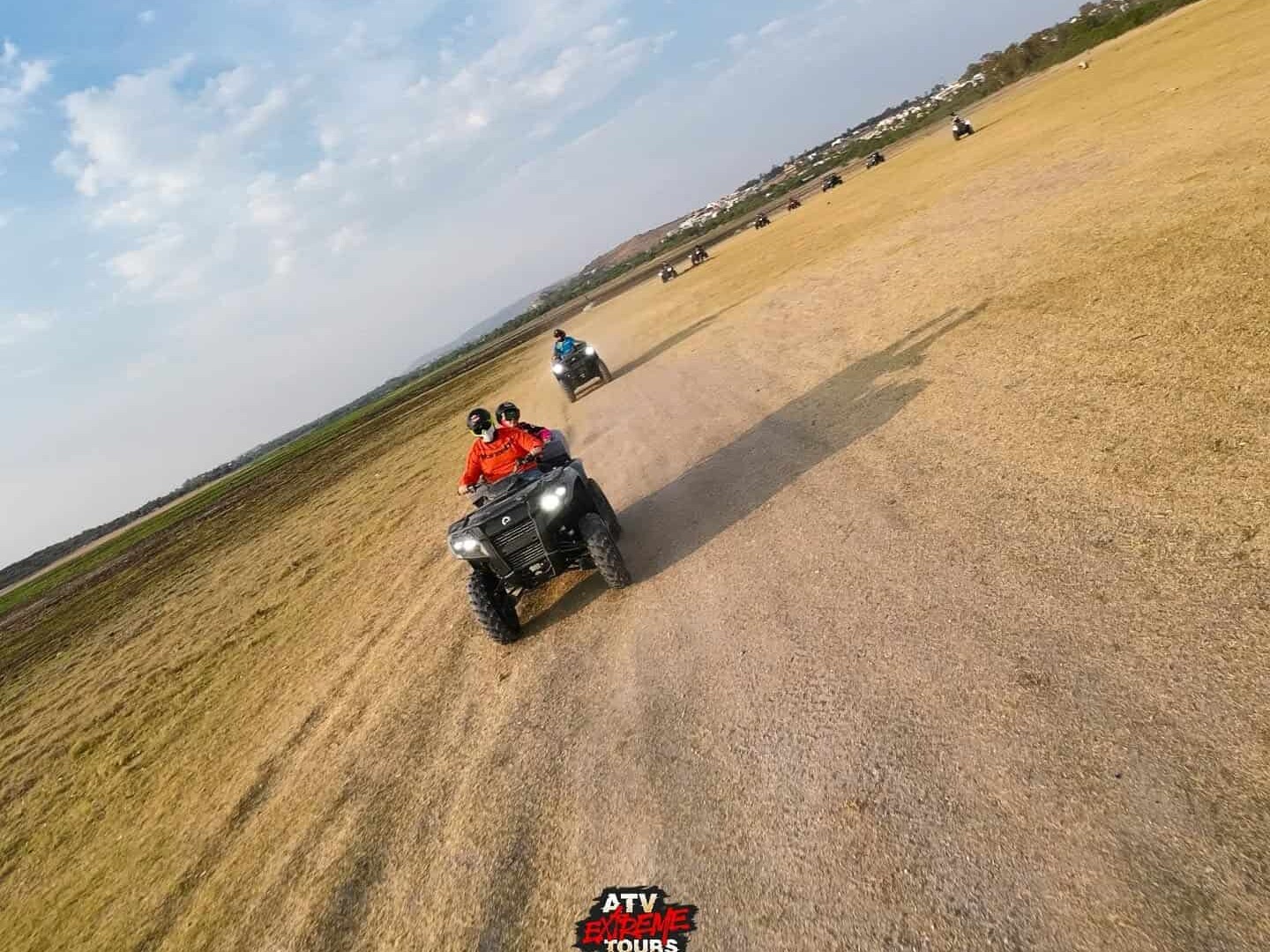 ATVs driving across an open field on the outskirts of San Miguel de Allende.
