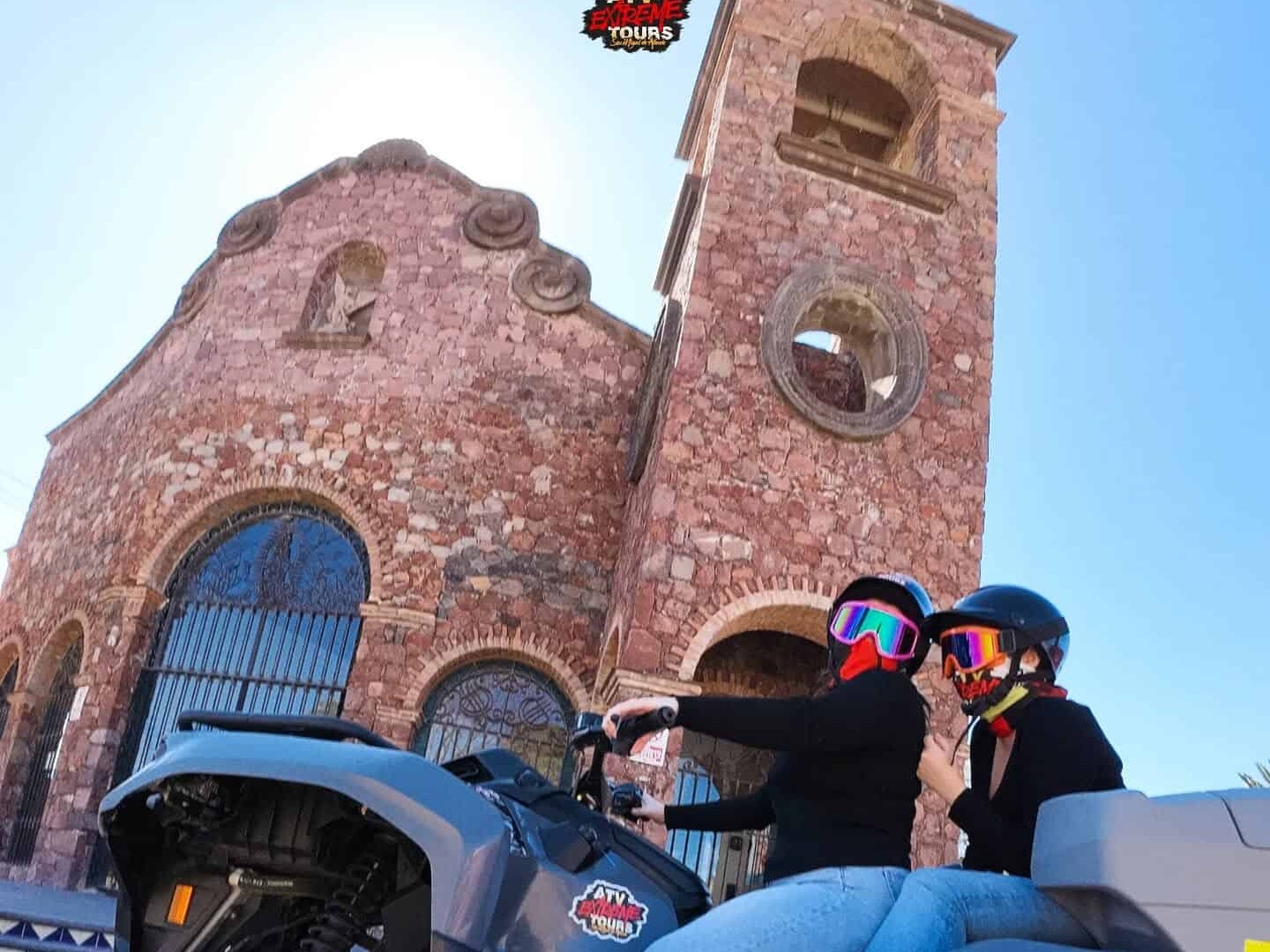ATV riders in front of a church, on a tour of the surroundings of San Miguel de Allende.
