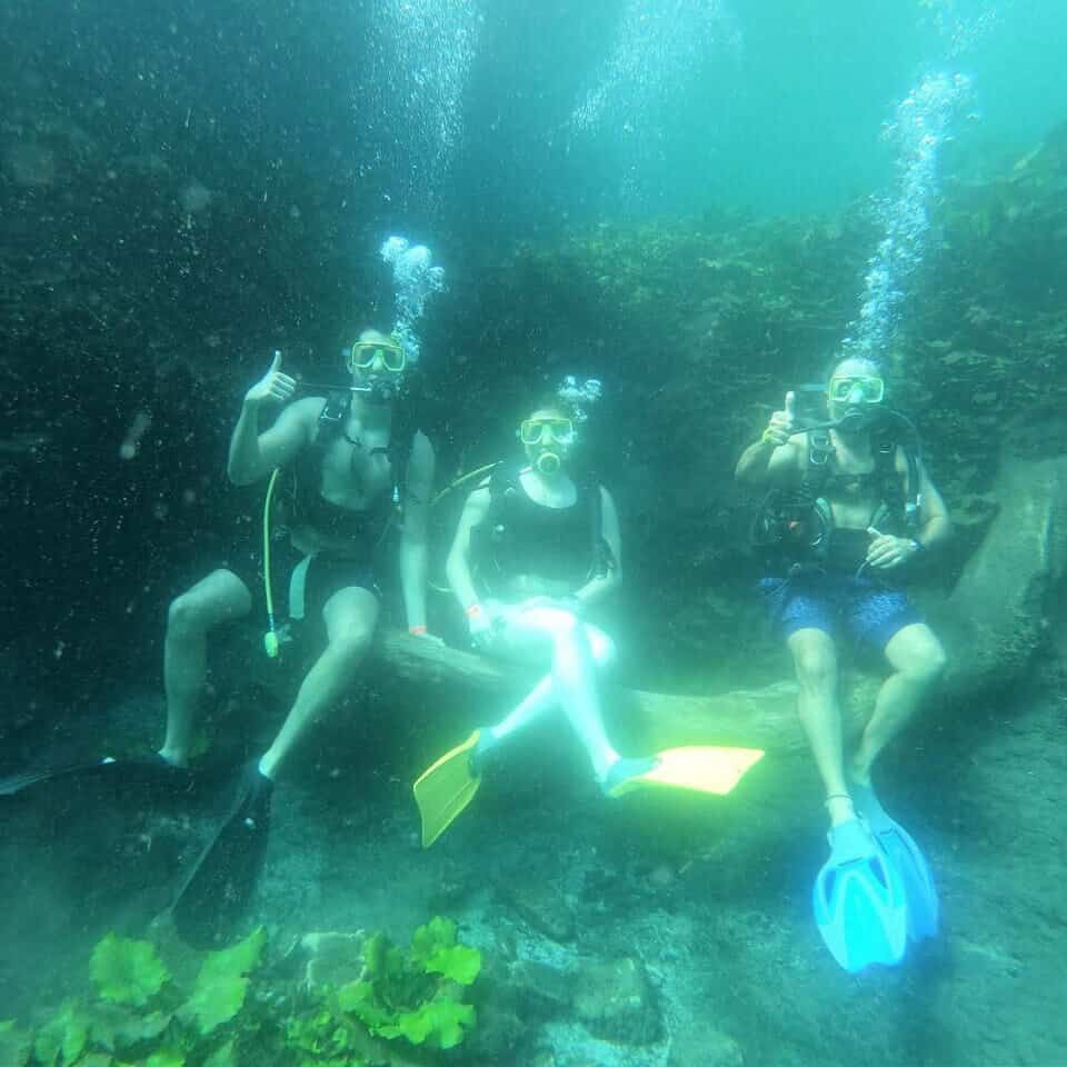 People practicing scuba diving in a cenote in Guanajuato, exploring crystal clear waters and formations.