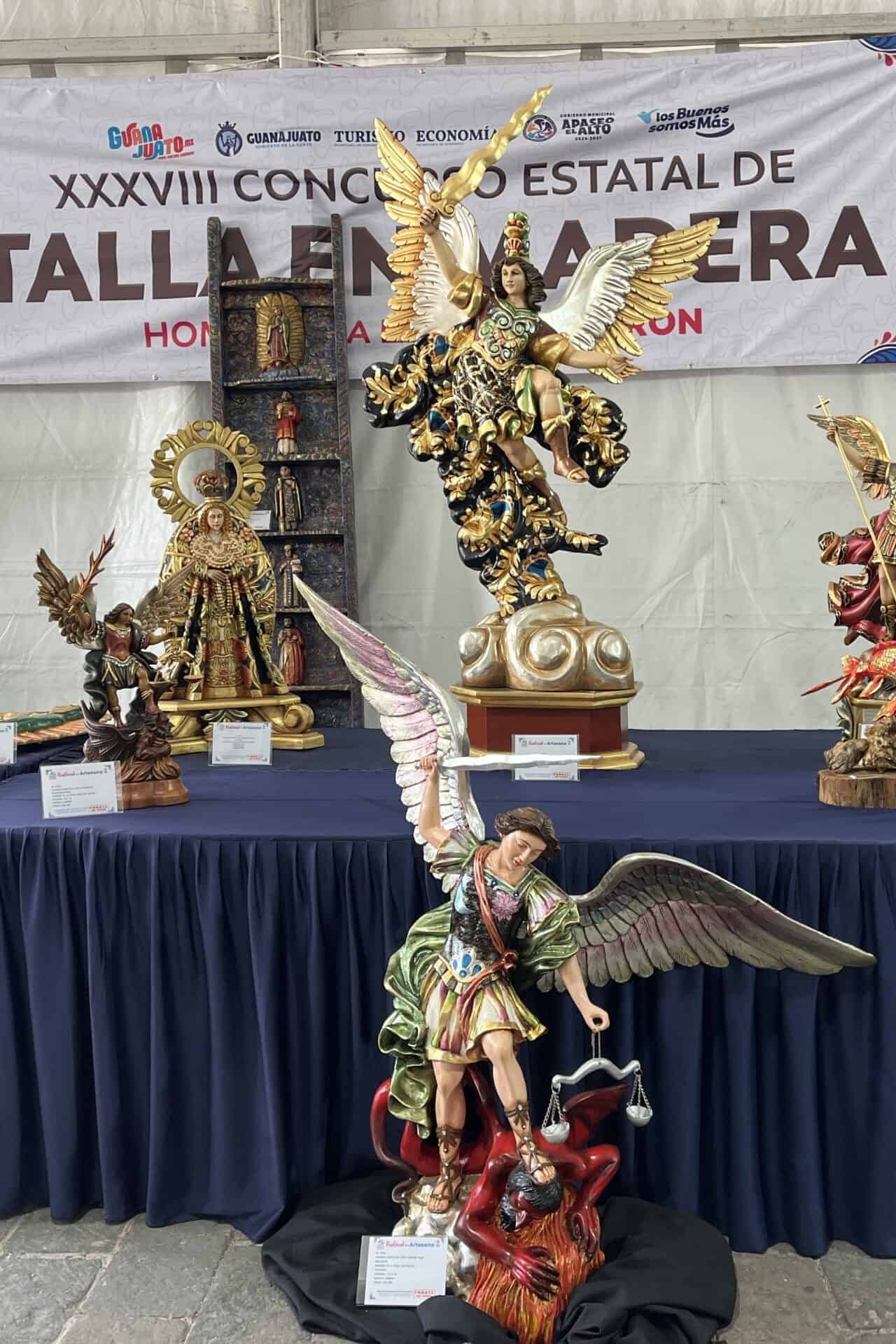 Ceramic and wood sculptures exhibited at the cultural event.