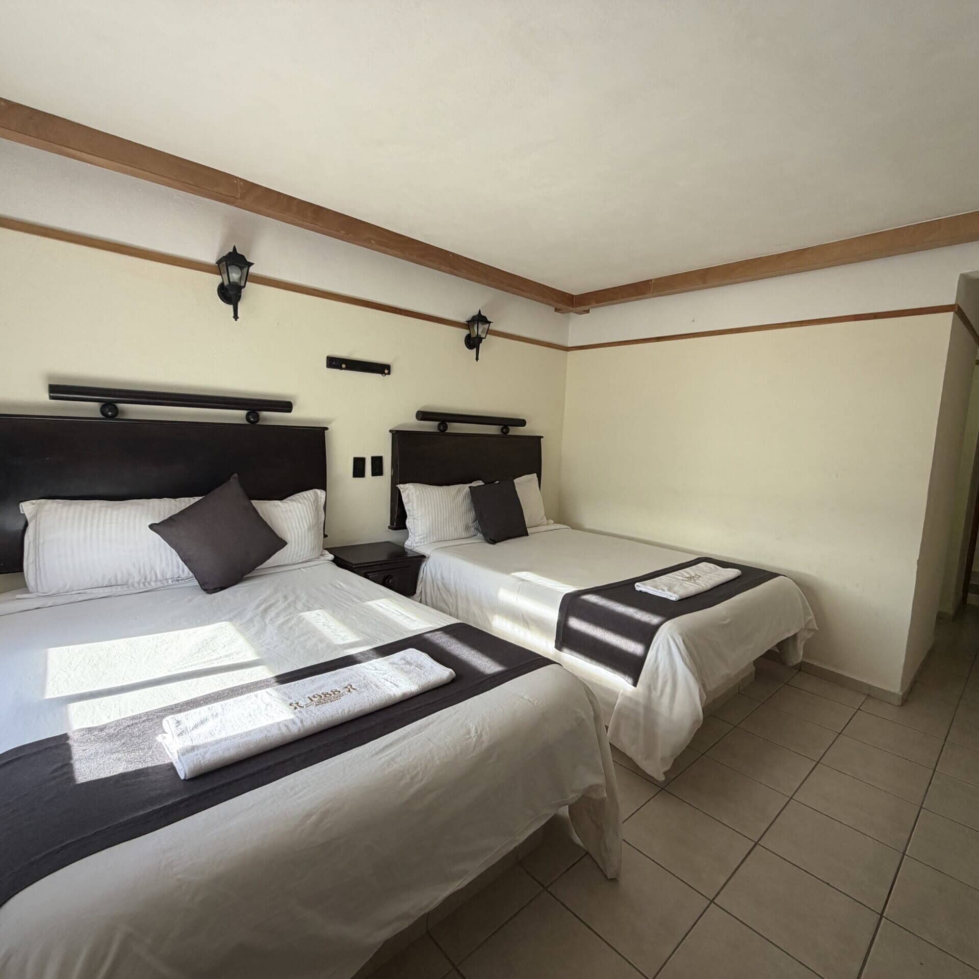 Rooms at Hotel Colonial 1988, with comfortable beds and simple decor, ideal for a stay.