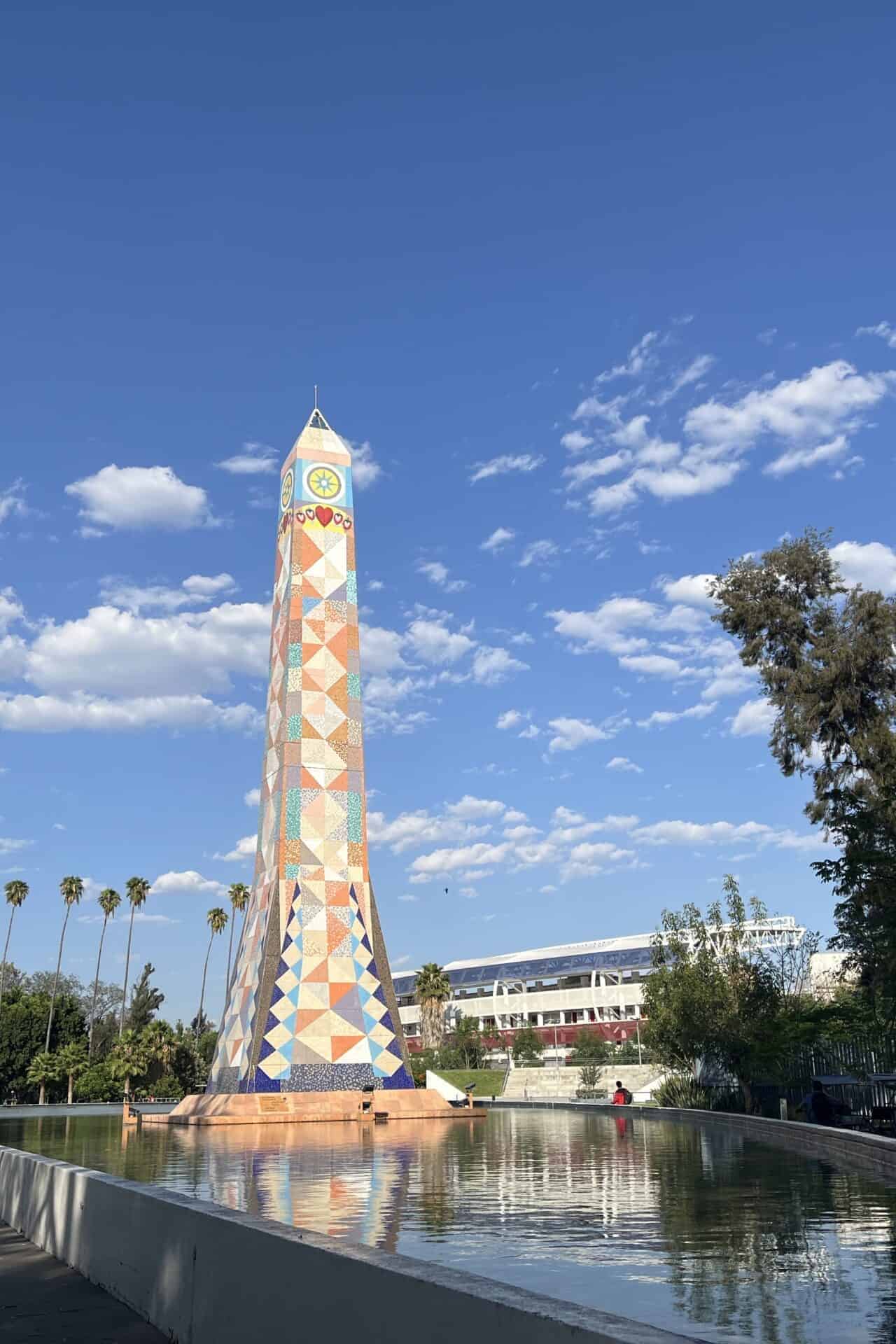 Torre Irekua, Irapuato's symbol, in a park with green areas and reflected in the water.