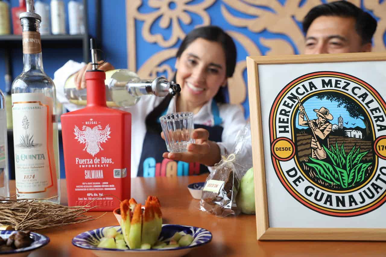 Mujer sirviendo mezcal en el stand de Herencia Mezcalera de Guanajuato.