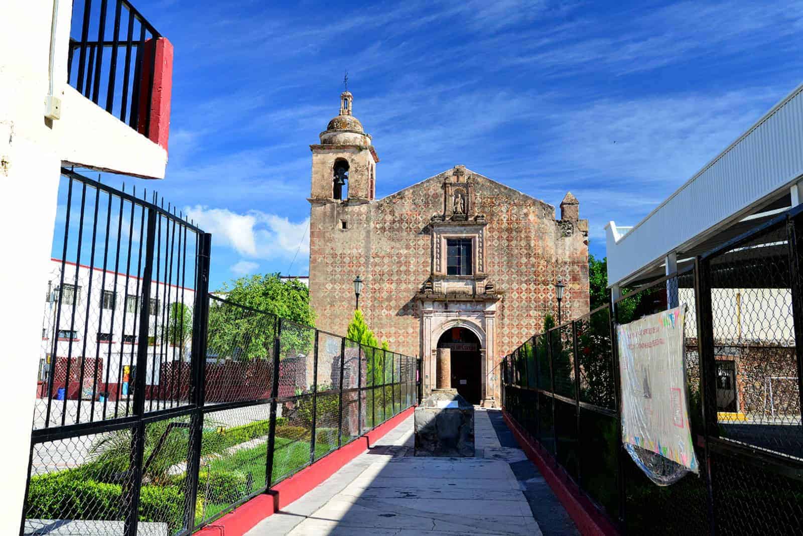 Fachada de la catedral de Guanajuato con camino peatonal y cielo azul brillante.
