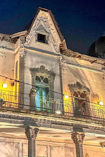Illuminated facade of a 19th-century mansion on Paseo de la Presa, Guanajuato.