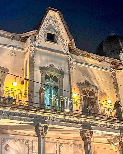 Illuminated facade of a 19th-century mansion on Paseo de la Presa, Guanajuato.