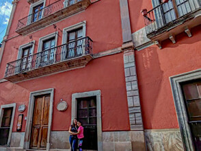 Red facade of the Diego Rivera House Museum in downtown Guanajuato.
