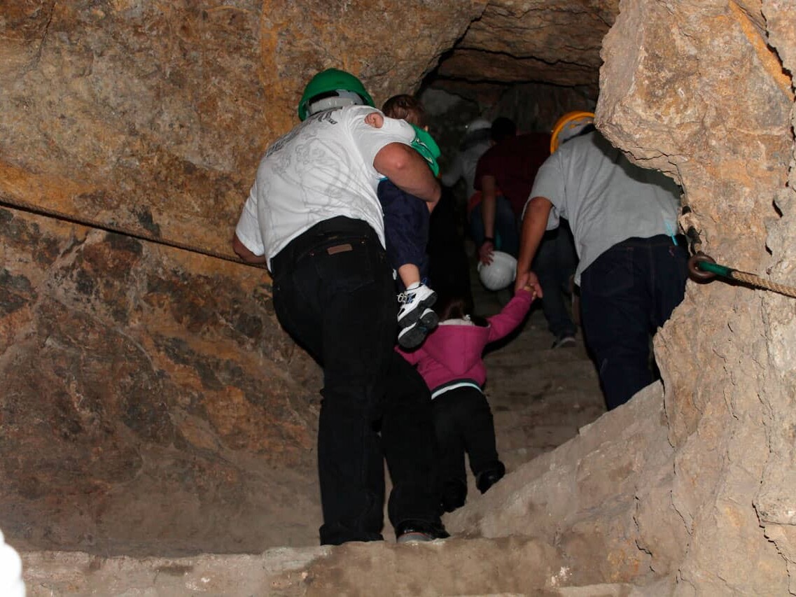 Helmeted visitors coming out of a mine in Guanajuato.
