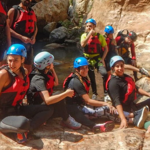 Group wearing helmets and life jackets during a canyoning tour in a canyon in Guanajuato.