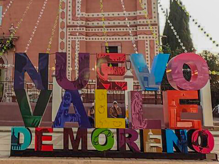 Colorful monumental letters of Nuevo Valle de Moreno in front of its church, León, Guanajuato.