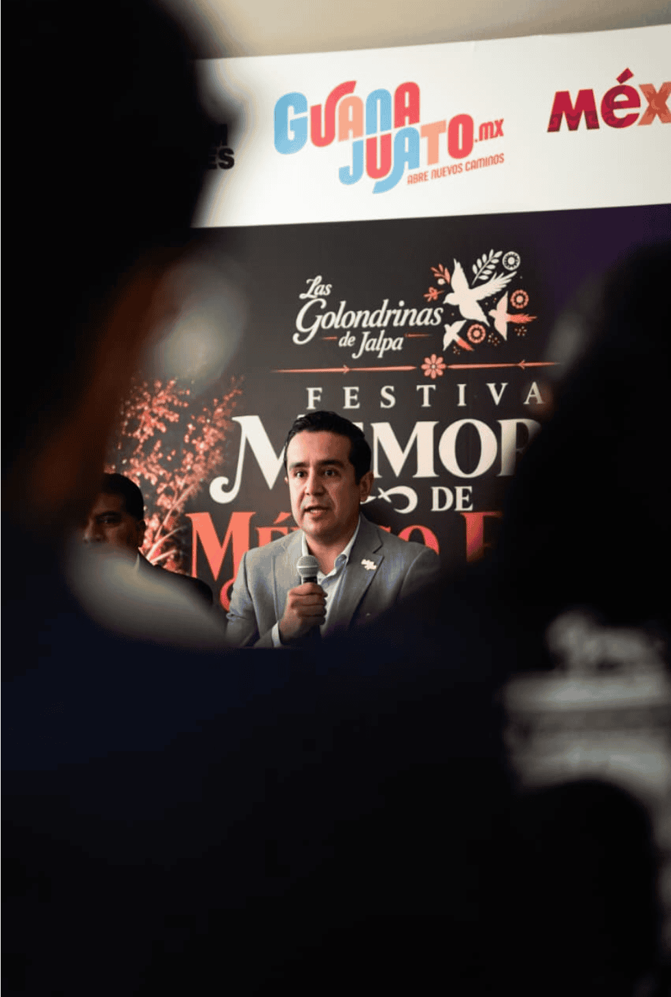 Hombre hablando en escenario durante festival Memorias de México en Jalpa de Cánovas.