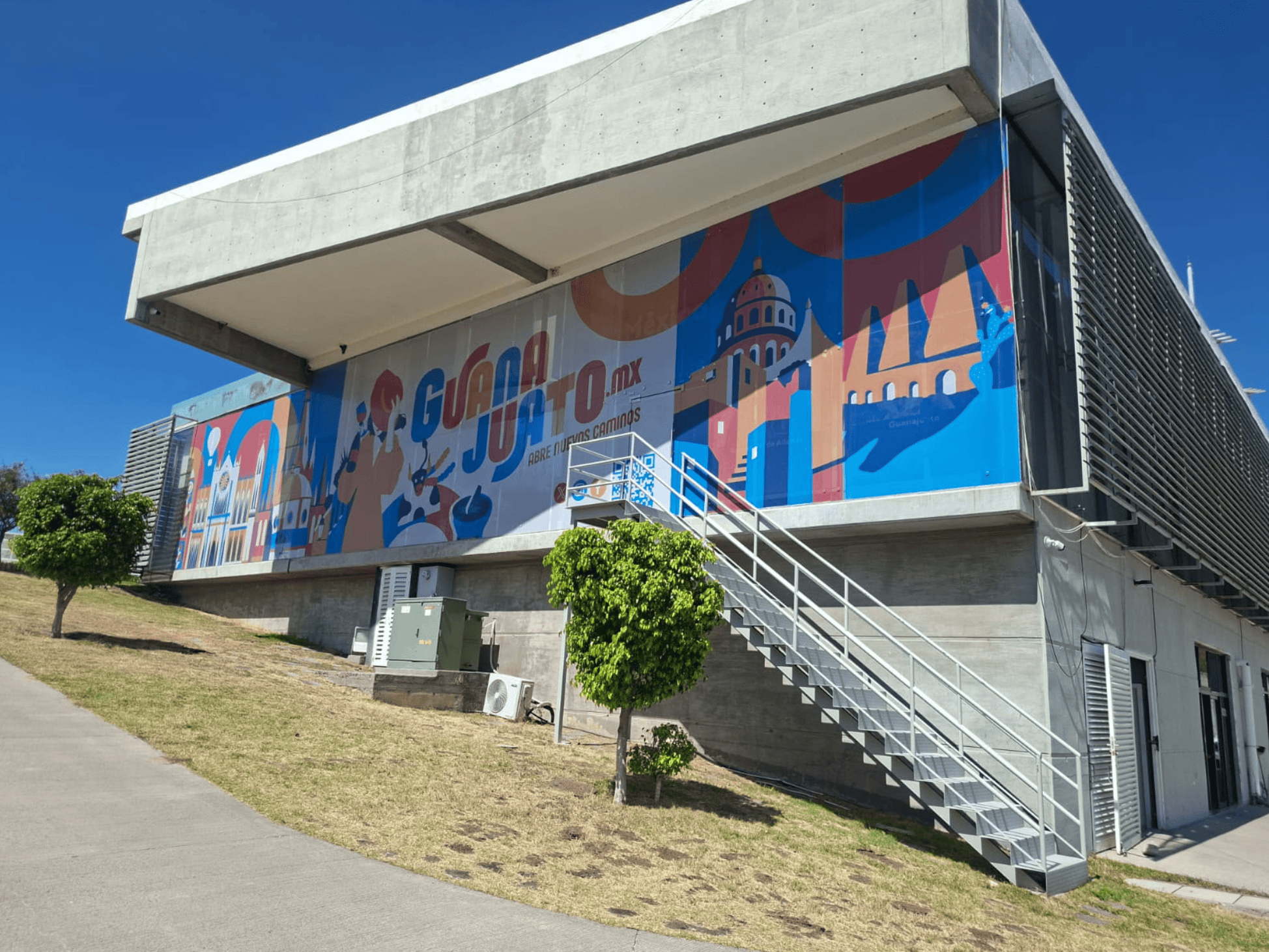 Edificio con mural de promoción turística de Guanajuato en León, México.